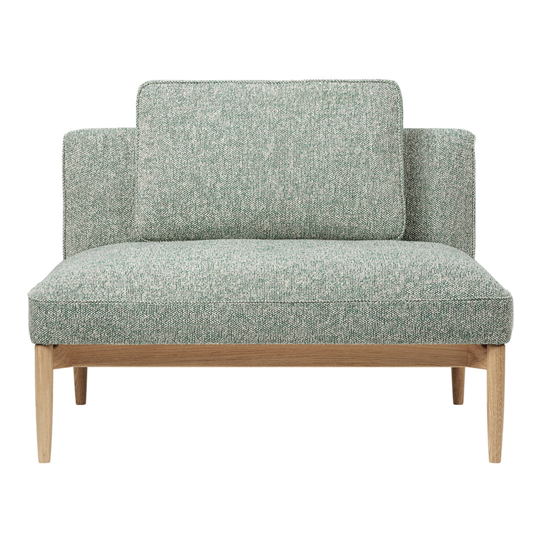 Green patterned loveseat with textured fabric and light wood legs, perfect for modern living spaces.
