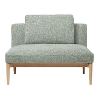 Green patterned loveseat with textured fabric and light wood legs, perfect for modern living spaces.