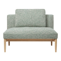 Green patterned loveseat with textured fabric and light wood legs, perfect for modern living spaces.
