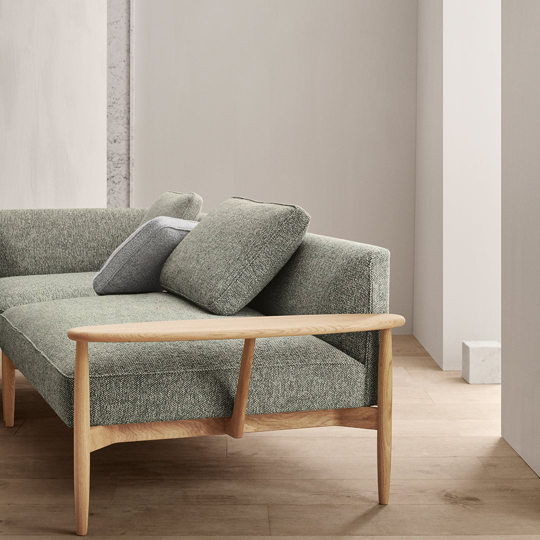 Grey textured upholstery sofa with light wooden legs, featuring simple, modern design elements.