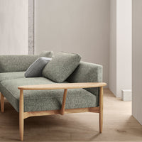 Grey textured upholstery sofa with light wooden legs, featuring simple, modern design elements.