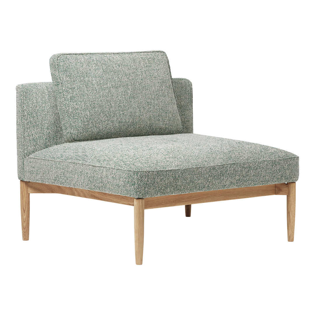 Light green upholstered chair with a textured pattern and natural wood legs. Perfect for modern decor.