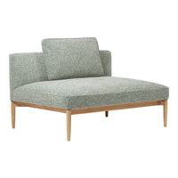 Light green textured fabric armchair with wooden legs, featuring a minimalist design and soft, modern patterns.