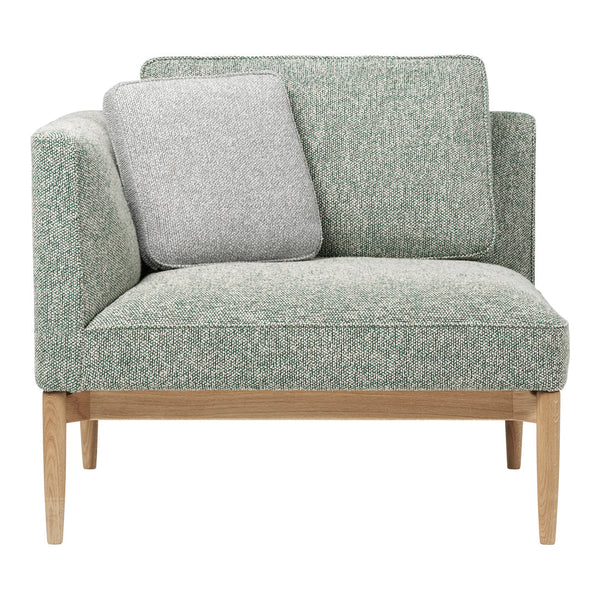 Light green textured upholstery with a gray accent pillow and natural wood legs, perfect for stylish living spaces.