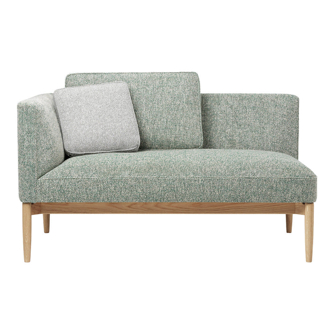 Light green upholstered sofa with a textured pattern and a contrasting gray cushion on a natural wood frame.
