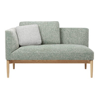 Light green upholstered sofa with a textured pattern and a contrasting gray cushion on a natural wood frame.