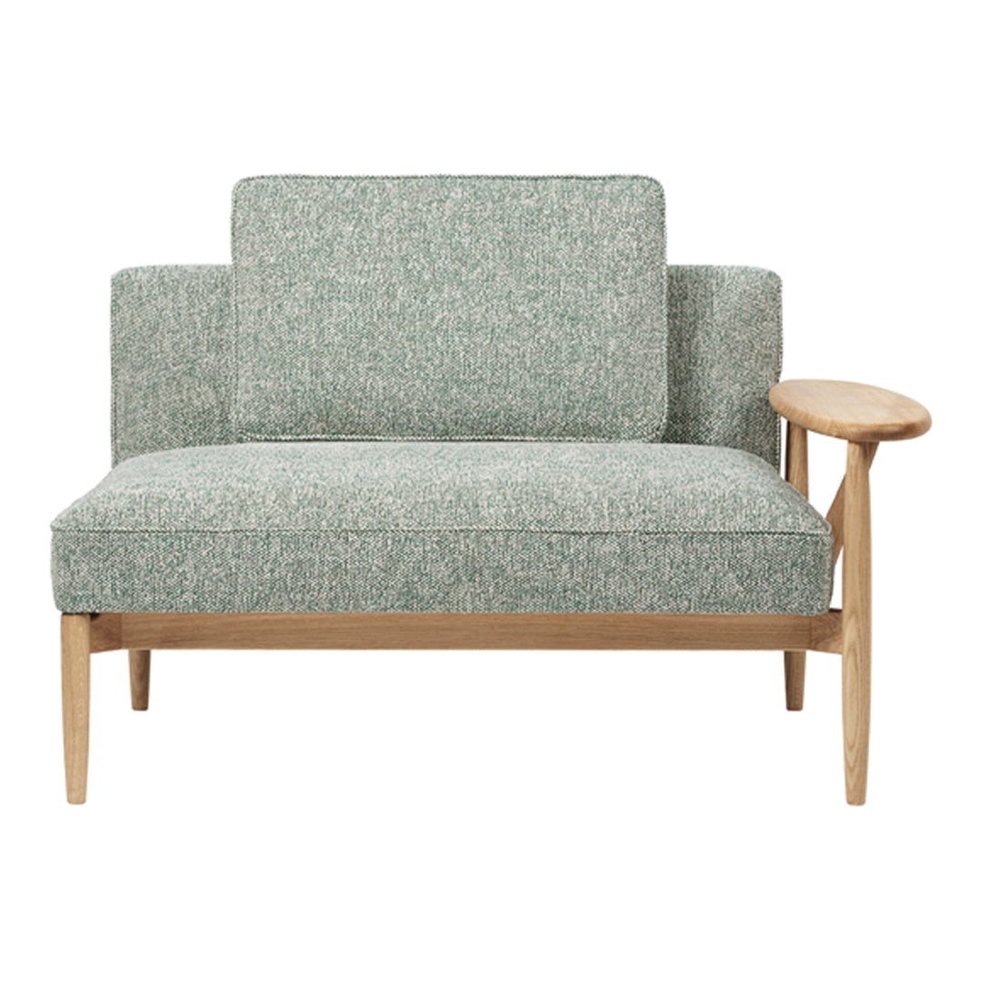 Teal and white textured fabric sofa with wooden armrest, featuring a simple, modern design.