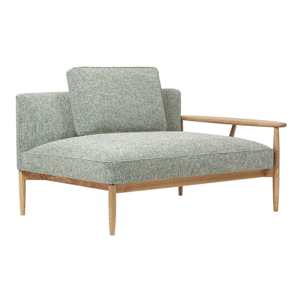 Mint green upholstered chair with a subtle textured pattern and natural wood legs. Modern, minimalist design.