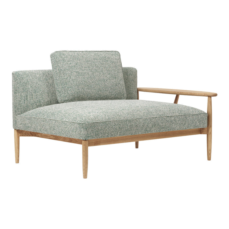 Mint green upholstered chair with a subtle textured pattern and natural wood legs. Modern, minimalist design.