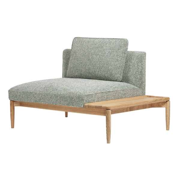 Green patterned fabric lounge chair with natural wood accents and minimalist design. Perfect for modern interiors.