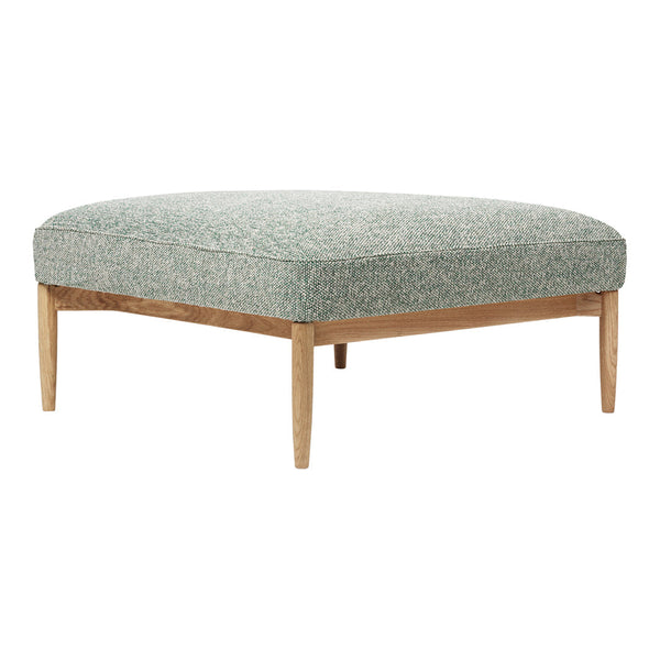 Green patterned ottoman with light wood legs, featuring a textured fabric design. Perfect for modern decor.