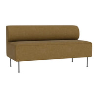 Brown upholstered bench with a cylindrical back, featuring a smooth texture and sleek metal legs.