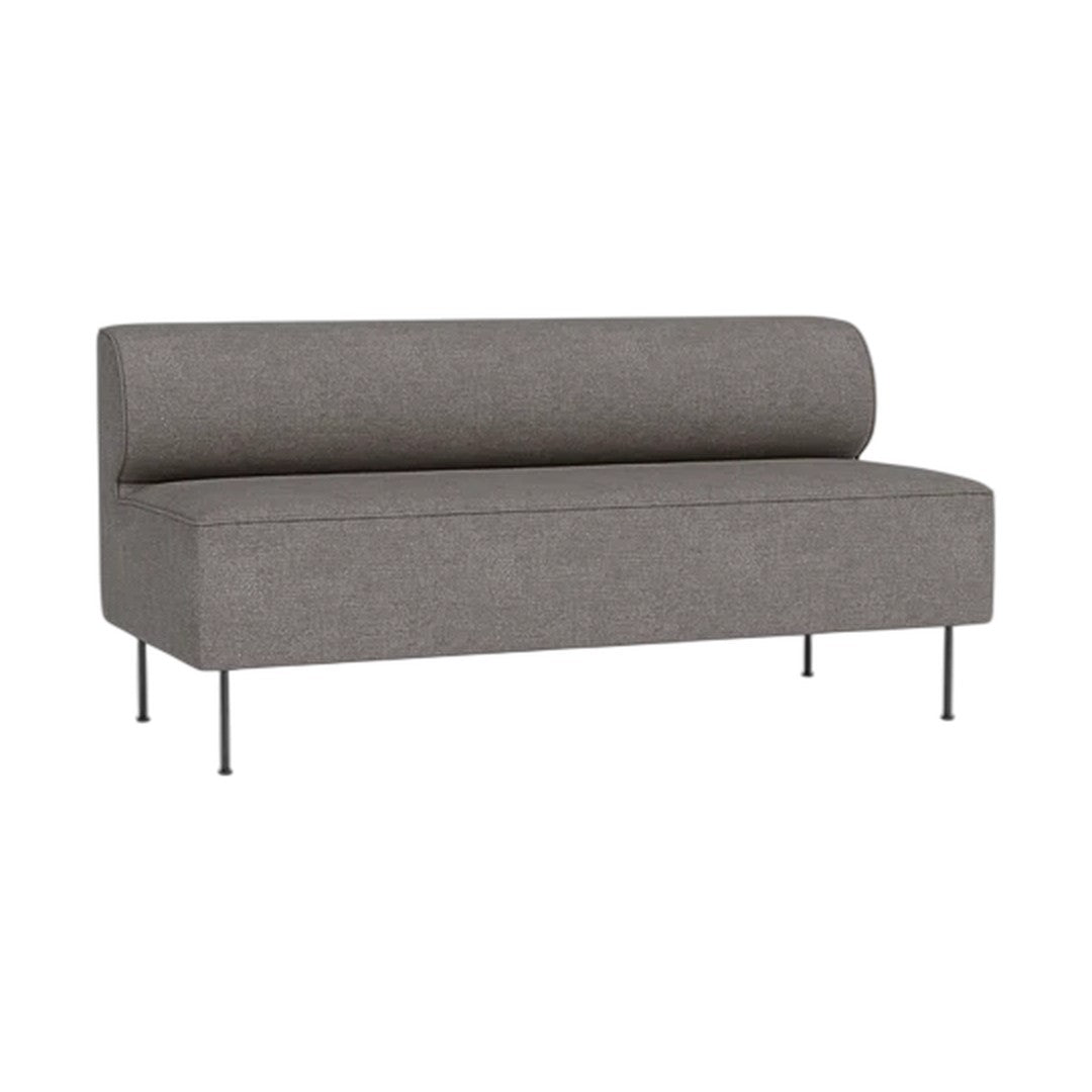 Grey upholstered sofa with a rounded back and sleek metal legs, showcasing a minimalist design.