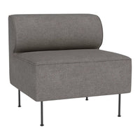 Gray upholstered accent chair with a smooth surface and minimalist design, featuring rounded backrest and sleek metal legs.