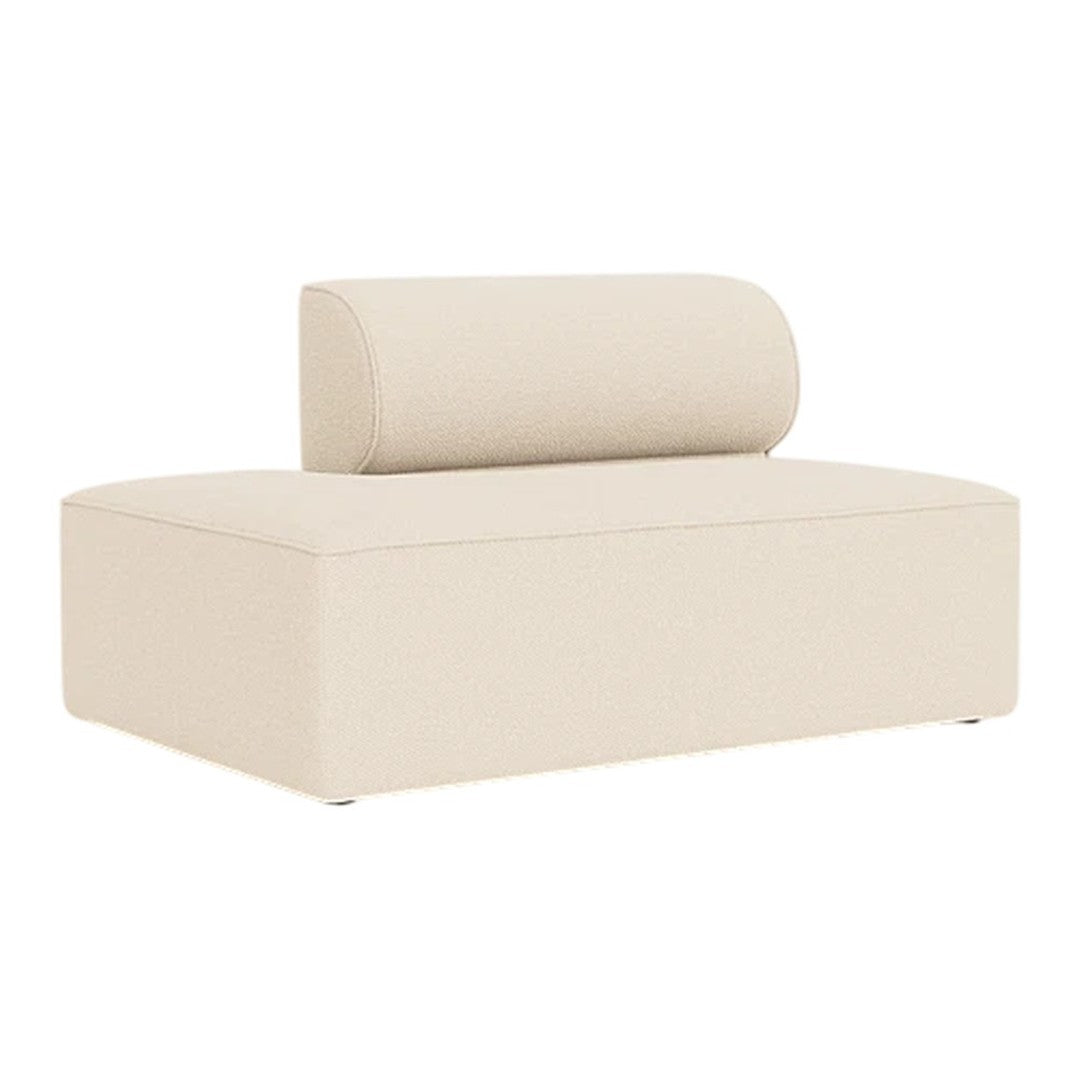 Beige upholstered chaise lounge with a rounded backrest, featuring a minimalist design and smooth, clean lines.