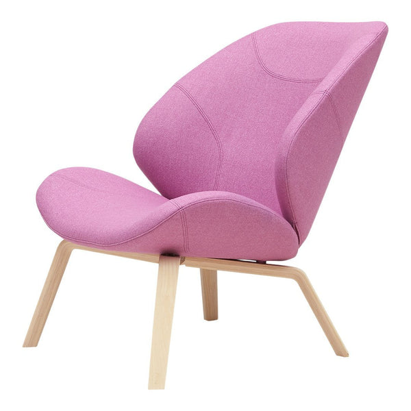 Soft pink upholstered lounge chair with a modern, sleek design and natural wood legs. Perfect for stylish interiors.