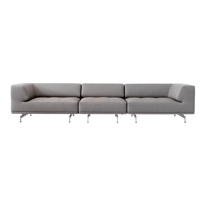 Gray sectional sofa with sleek, modern lines and subtle tufted detailing, supported by chrome legs.