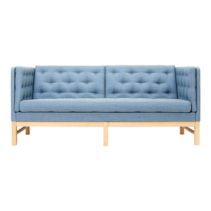 Light blue tufted fabric sofa with a minimalist wooden base. Elegant and modern design, perfect for any living space.