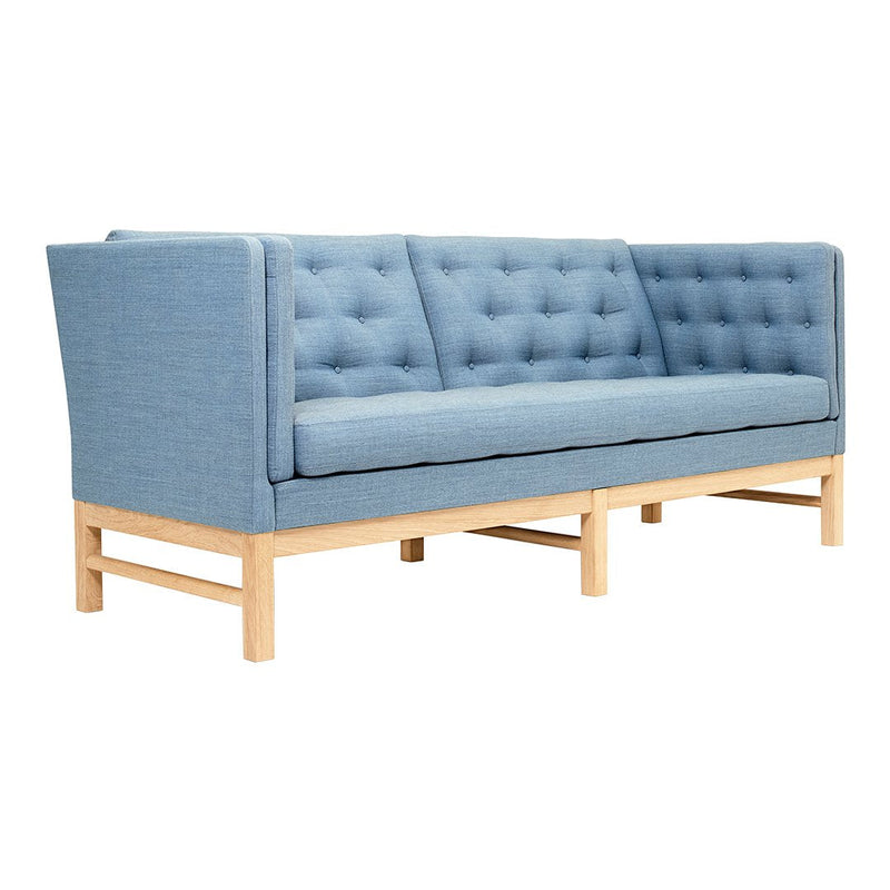 Light blue tufted sofa with a clean design, featuring a natural wooden base for a modern aesthetic.