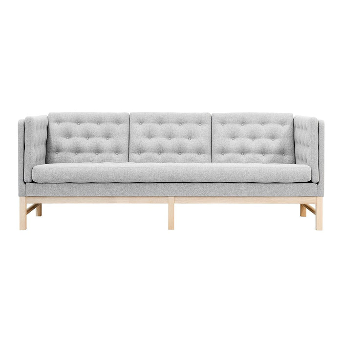 Gray tufted sofa with a modern design, featuring wood legs and a sleek, minimalist look. Ideal for contemporary spaces.