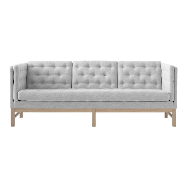 Light gray tufted sofa with a minimalist design and natural wood legs, perfect for modern interiors.