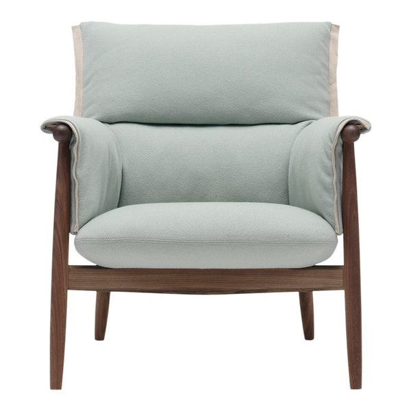 Light mint green upholstered armchair with wooden frame and cream-colored accent at the top. Modern and stylish design.