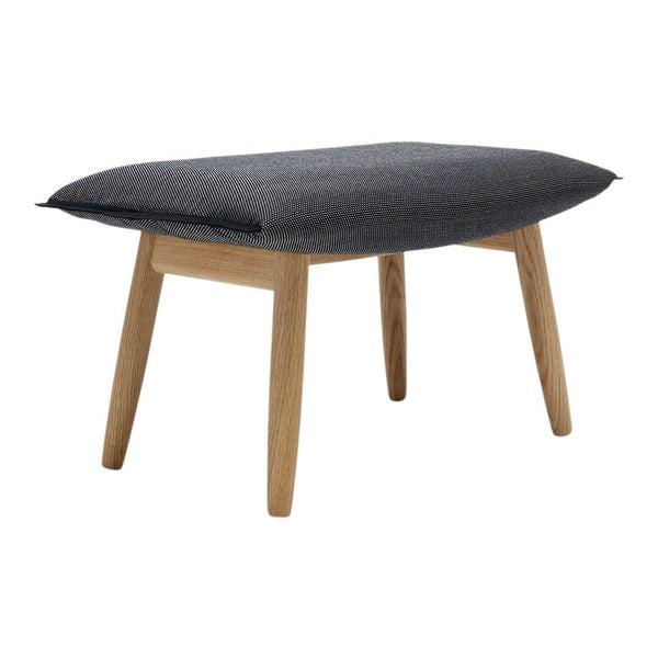 Gray padded bench with a textured fabric top and natural wood legs, perfect for modern decor.