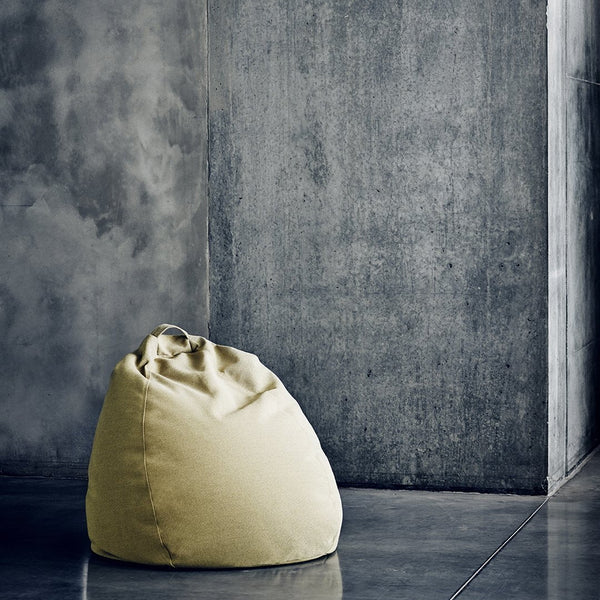 Yellow bean bag chair against a textured gray wall, ideal for contemporary home decor.