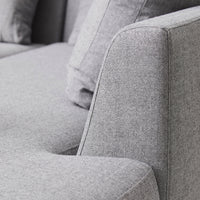 Gray upholstered sofa with subtle texture and clean lines, featuring a modern design and soft cushions.