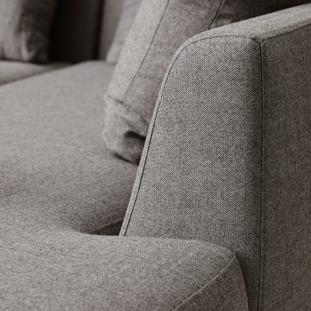 Gray textured fabric with a subtle pattern, showcasing clean lines and a modern design aesthetic.