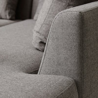 Gray textured fabric upholstery with subtle pattern, showcasing a modern design and clean lines.