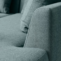 Textured gray fabric sofa with a subtle heather pattern, featuring soft, muted tones for a modern aesthetic.