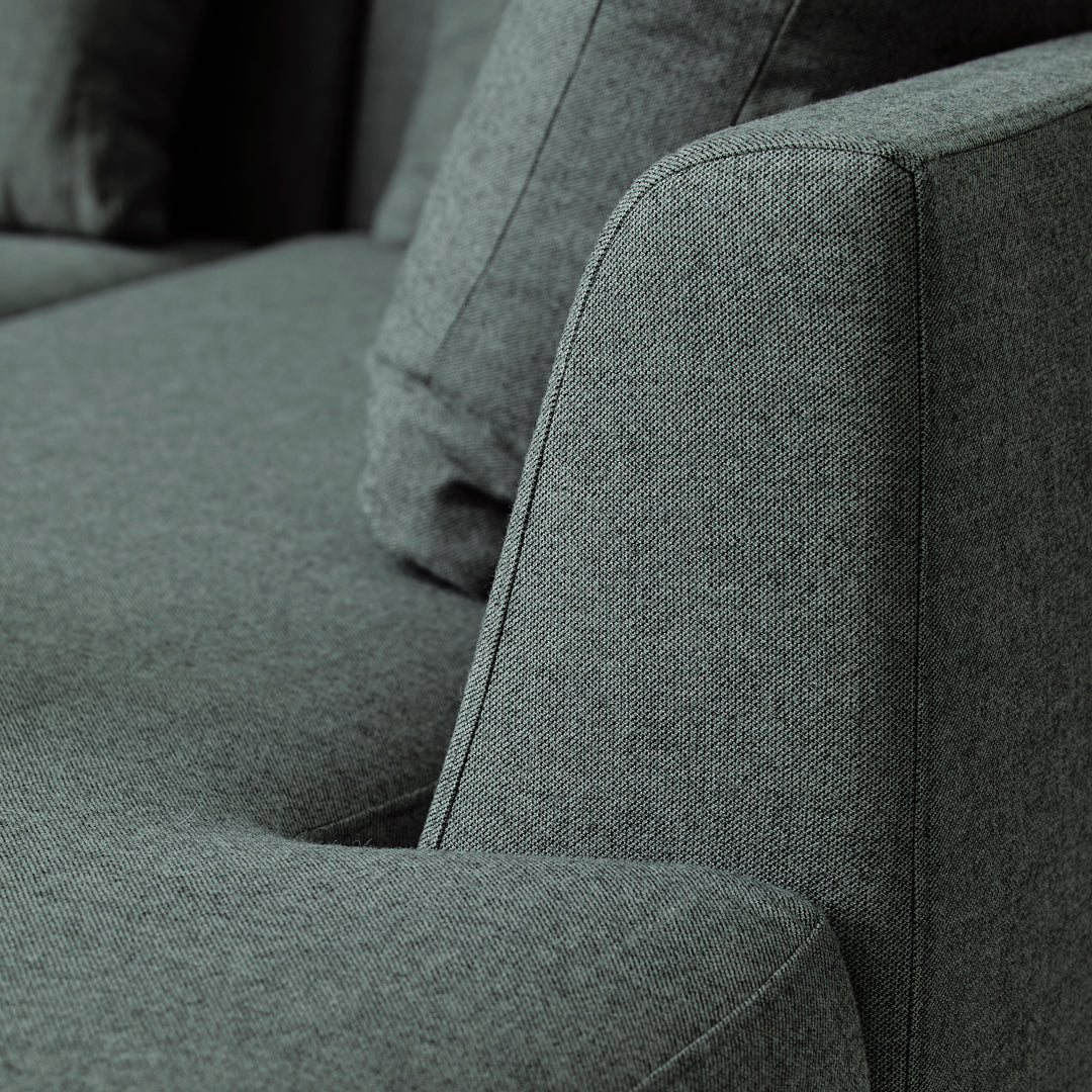 Soft gray fabric sofa with a subtle textured pattern, featuring clean lines and a modern design.