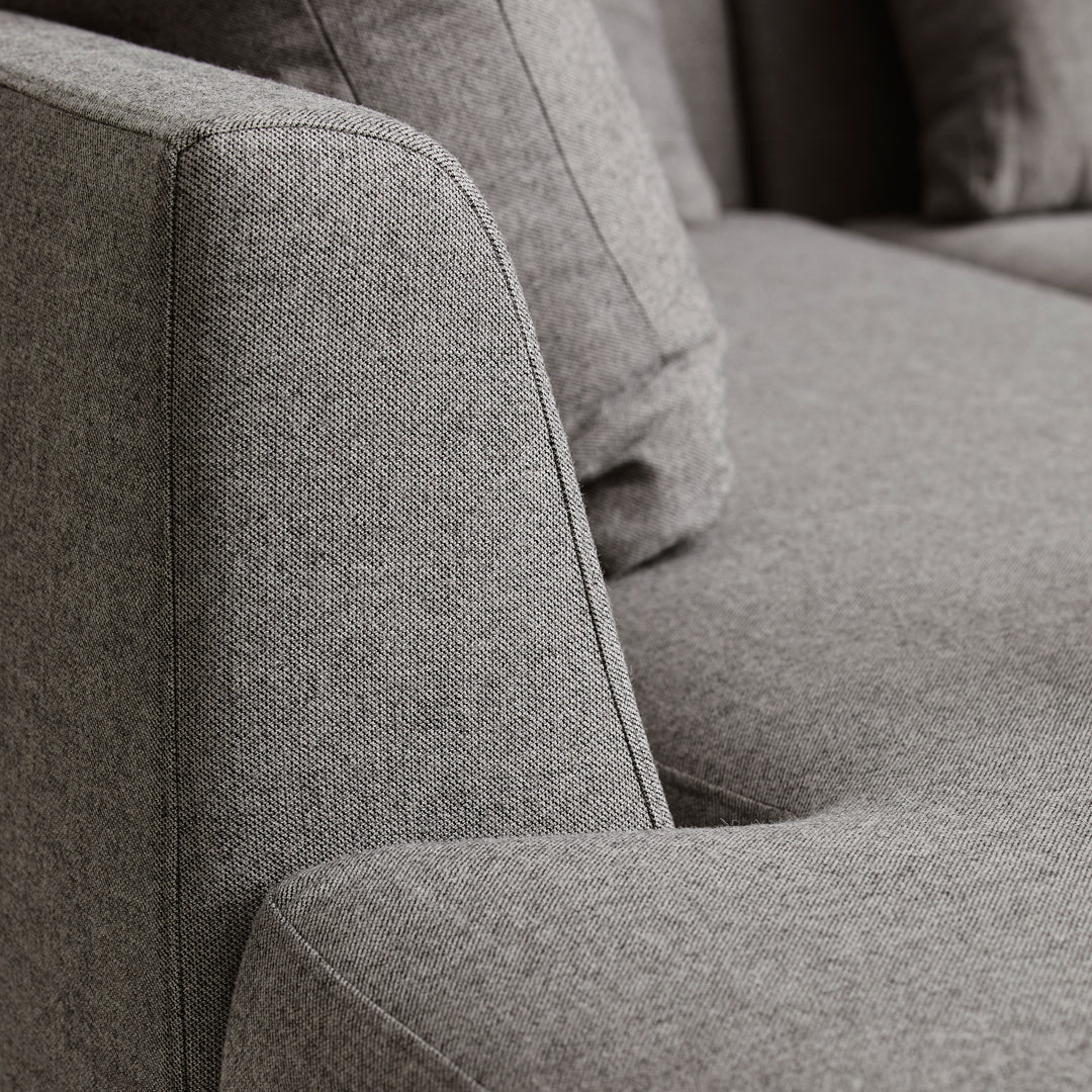 Gray textured sofa fabric with a contemporary design, featuring a smooth finish and subtle patterns.