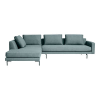 Light blue sectional sofa with a minimalist design and soft fabric upholstery, featuring clean lines and scattered cushions.
