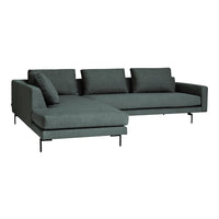 Modern dark teal sectional sofa with a minimalist design, featuring solid colors and clean lines.