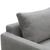 Gray textured fabric sofa with a matching accent pillow, showcasing a modern and minimalist design.