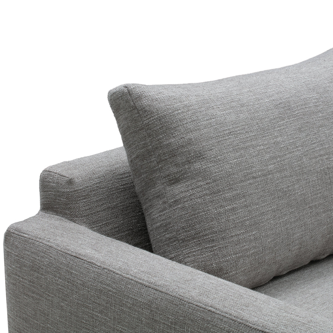 Grey textured sofa with a matching pillow, showcasing a subtle, modern pattern. Perfect for contemporary decor.
