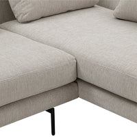 Light beige sofa sectional with a textured fabric and clean lines, complemented by black metal legs.