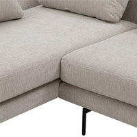 Light beige couch with a textured fabric and subtle pattern, featuring sleek black metal legs.