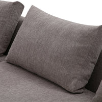 Gray textured fabric throw pillow on a modern sofa, featuring a subtle heathered pattern.