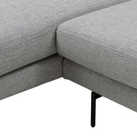 Gray upholstered sectional sofa with a textured fabric and sleek black metal legs. Minimalist and modern design.
