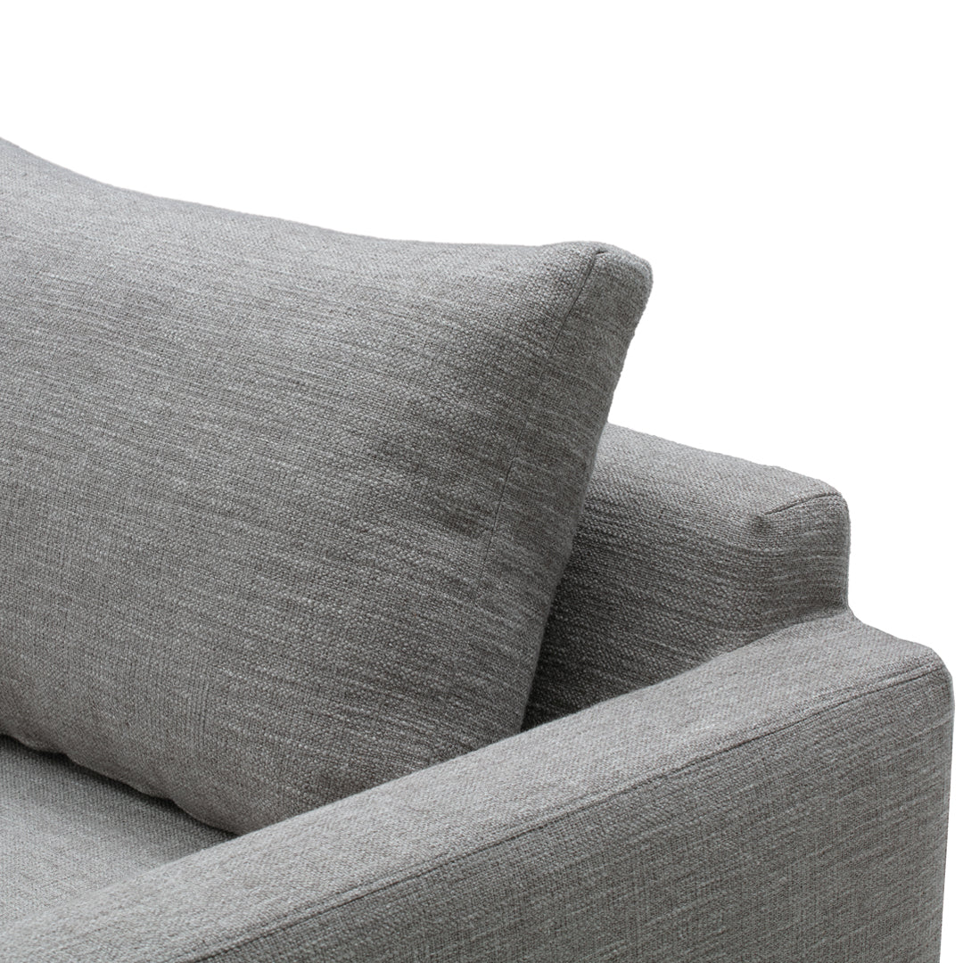Gray textured fabric sofa with a matching rectangular pillow, showcasing a sleek and modern design.