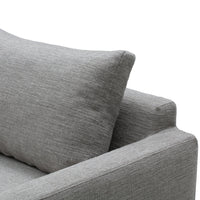 Gray textured sofa fabric with a subtle linen pattern and a supportive cushion. Perfect for modern interiors.