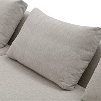 Light gray textured fabric pillow against a smooth gray backdrop, adding subtle elegance to modern decor.