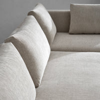 Neutral beige fabric sofa with a smooth, textured pattern and plush, supportive cushions.