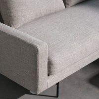 Light gray sofa with a subtle textured pattern and clean lines, complemented by a sleek black metal base.
