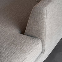 Gray textured fabric sofa with a modern design, featuring a subtle woven pattern for added depth.