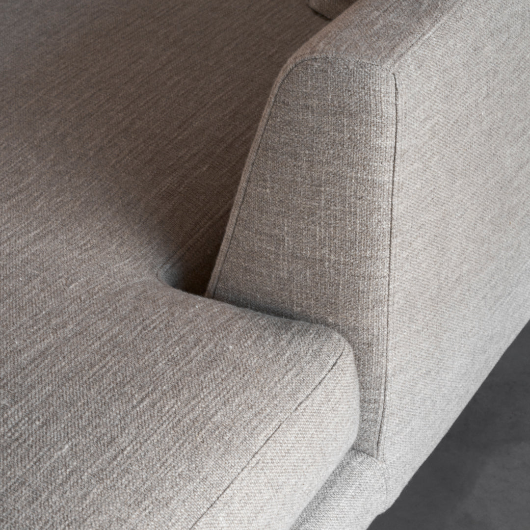 Gray textured fabric sofa with a modern design, featuring a subtle woven pattern for added depth.