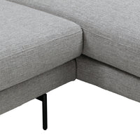 Gray fabric sectional sofa corner with subtle texture and sleek black metal legs, perfect for modern interiors.